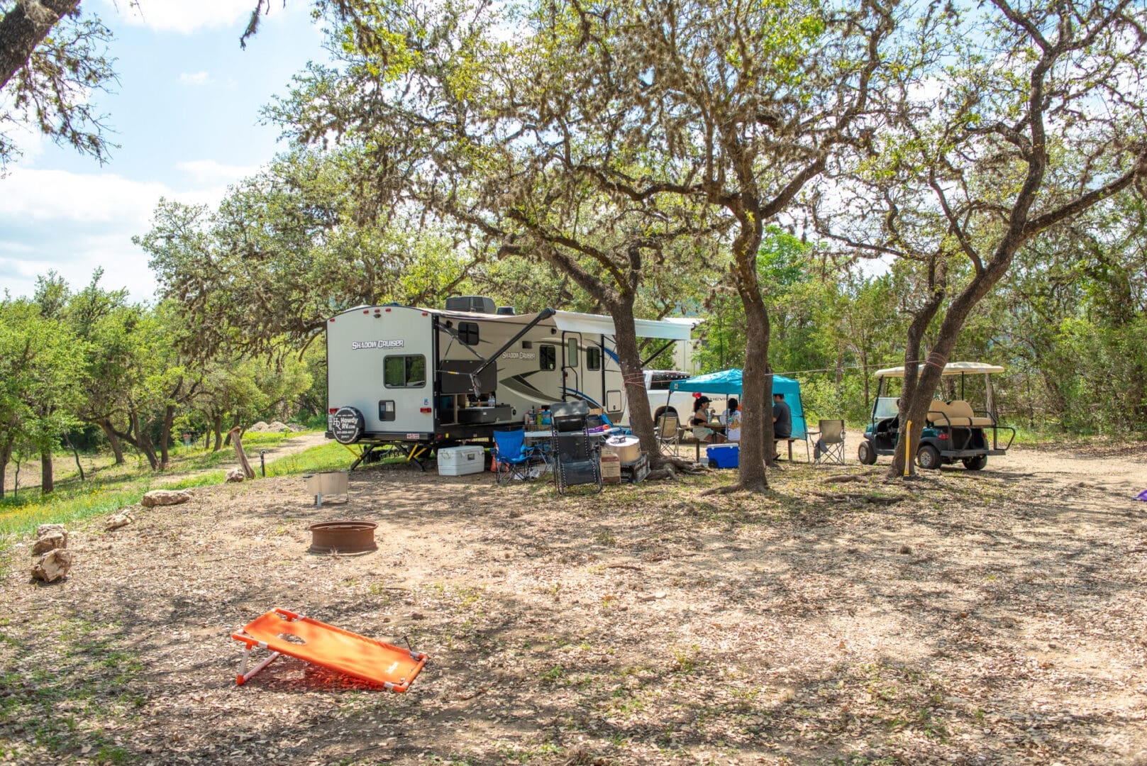 A group of people standing around an rv.