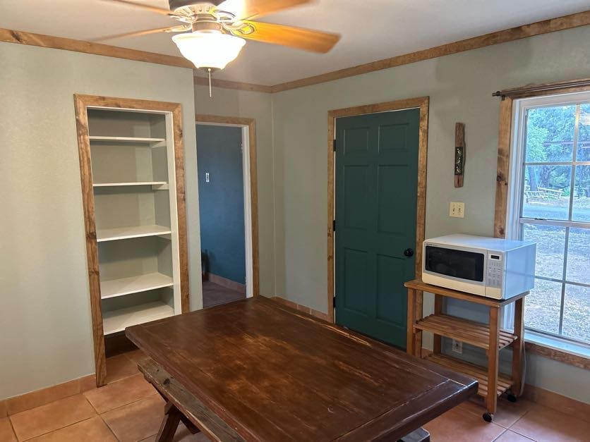 A room with a table and microwave in it