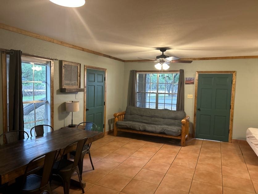 A living room with green doors and a table