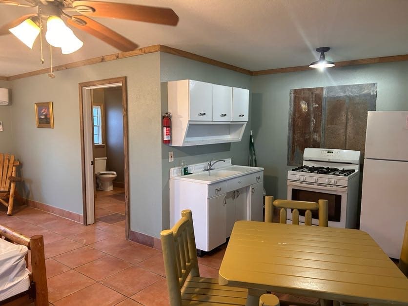 A kitchen with a table and chairs in it