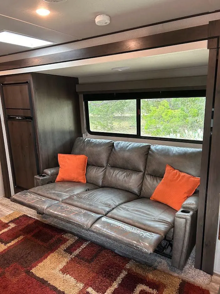 Brown leather reclining sofa in RV.