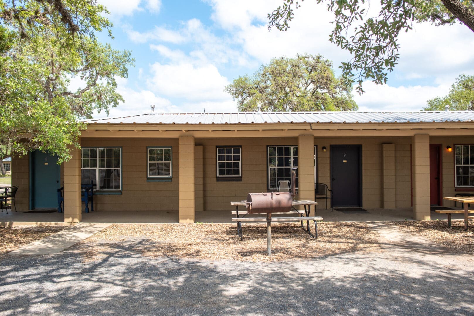 Exterior view of a cabin with a grill.