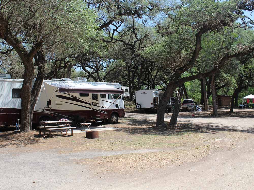 Two RVs parked in a campground.